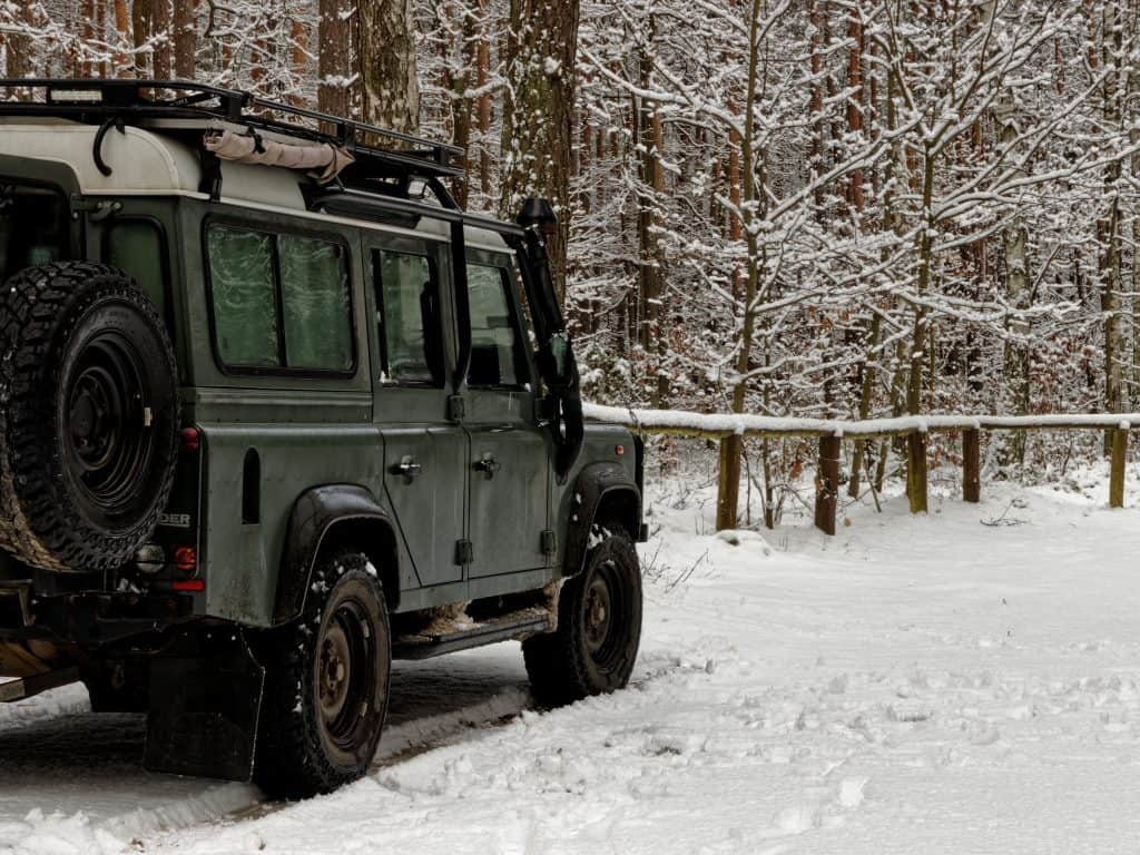 Zatory, Poland - January 13, 2021: Off road car parked in snowy forest area. Winter activities and recreation. Poland, Europe.